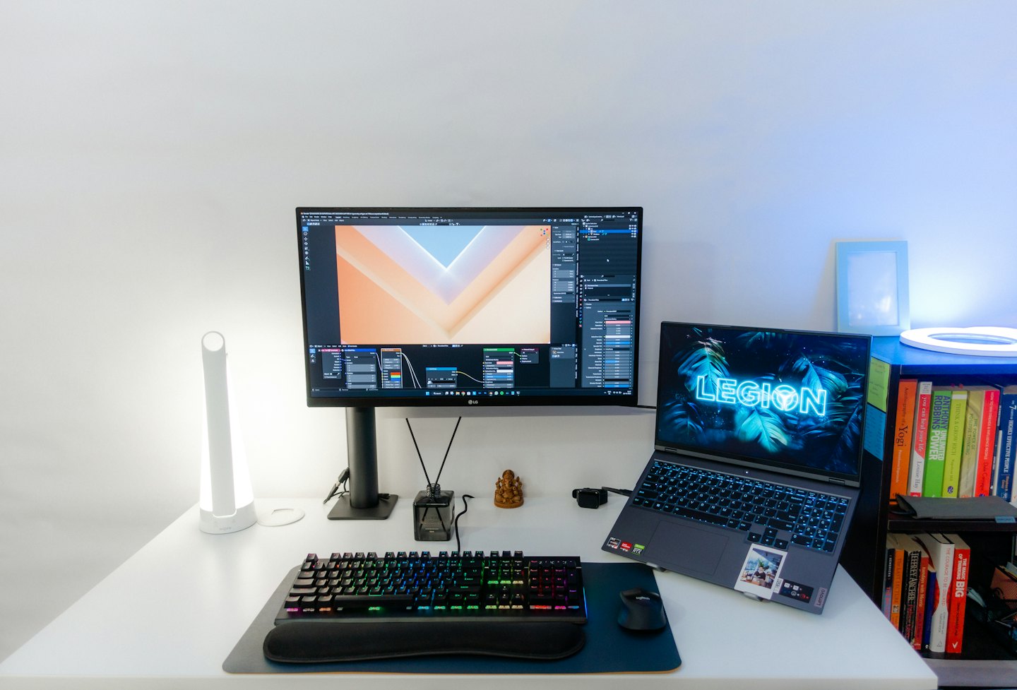 Modern white desk with open laptop and monitor.