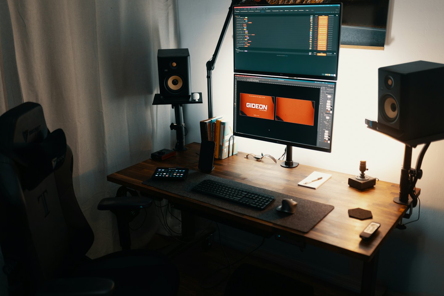 Dual monitors and computer peripherals arranged on a wooden desk.